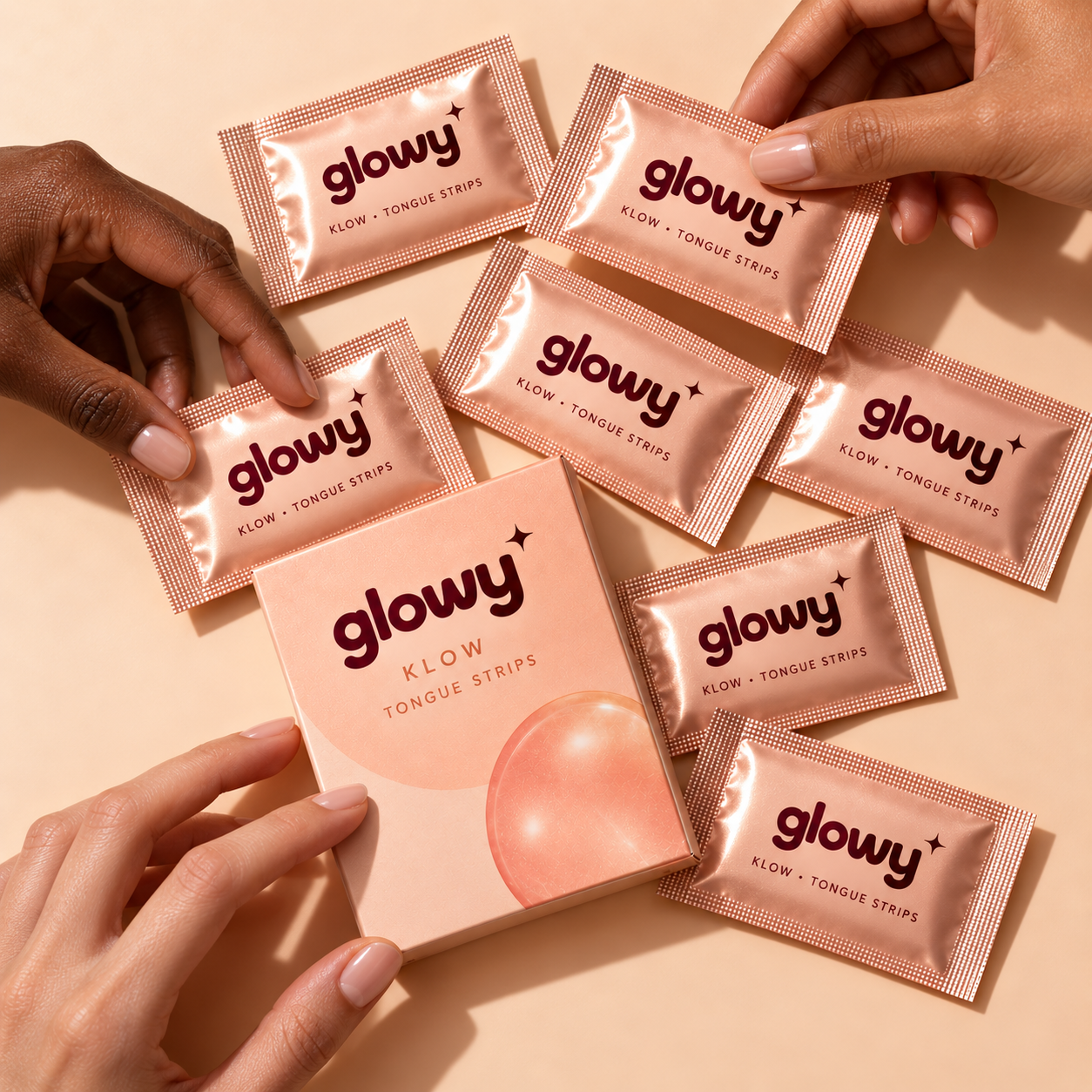 Glowy KLOW box surrounded by individual rose-gold sachets